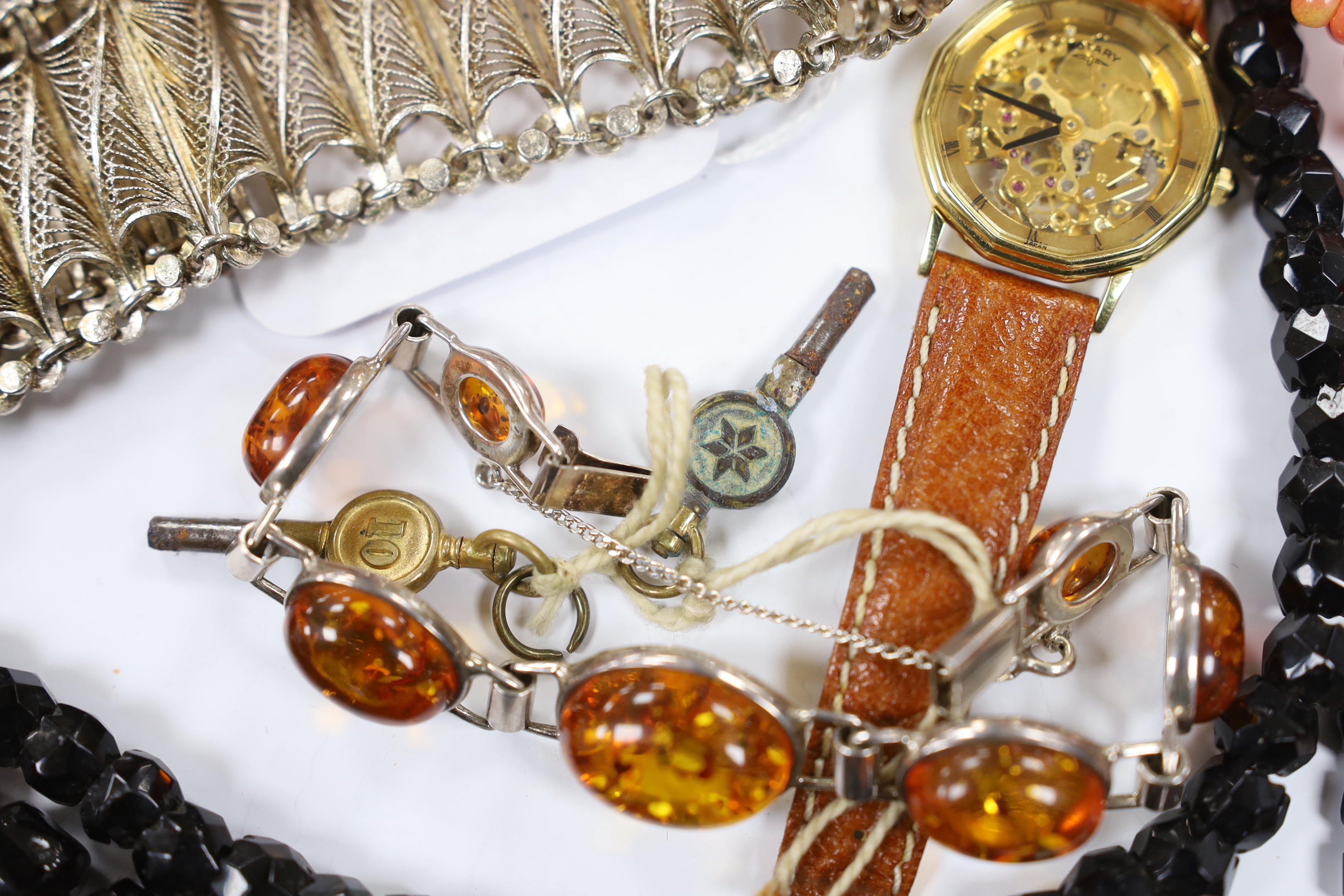 A continental 835 filigree white metal bracelet, a 925 and amber bracelet and other items including a wrist watch and a coral branch necklace.